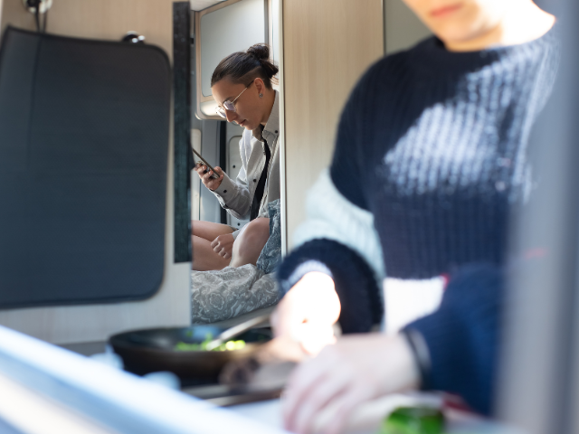 A woman is preparing food in a kitchen. Before You Go to an RV Show. RV Lifestyle Experts