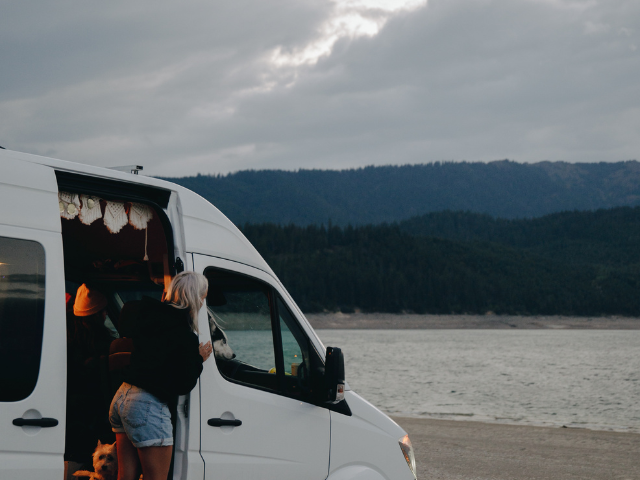 A group of people in a van on an avila beach camping trip. RV Lifestyle Experts