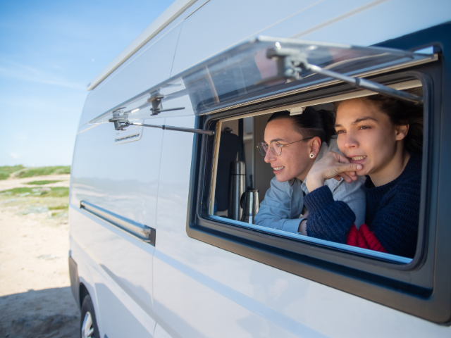 A couple of RV Shows in California looking out of a window. RV Lifestyle Experts