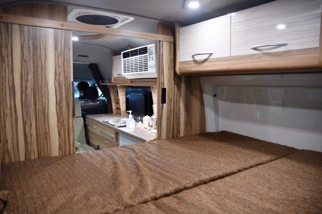 A room with two beds and a sink powered by solar energy. RV Lifestyle Experts