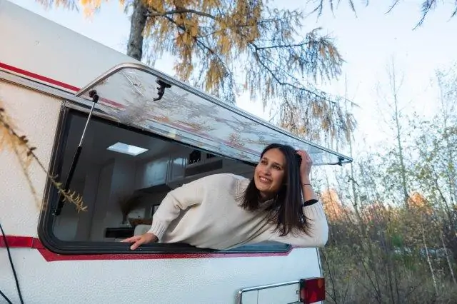A young woman looking out of the window to keep RV cool in extreme heat. RV Lifestyle Experts