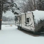 Experience Unforgettable Lake Perris Camping: Your Detailed Guide An rv parked in the snow near a river. RV Lifestyle Experts