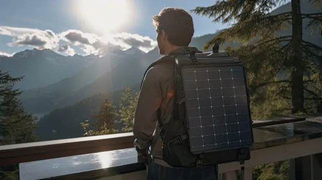 A man looking out over the mountains with a solar panel on his backpack. Solar Power Heater for RV. RV Lifestyle Experts