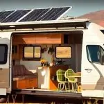 What You Need to Know on How Much Solar Power is Needed for an RV? A white rv with solar panels on the roof. RV Lifestyle Experts