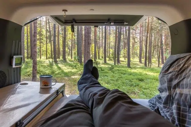 A person's feet are resting in the back seat, enjoying the heat from solar power heater for RV. RV Lifestyle Experts
